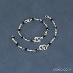 Load and play video in Gallery viewer, Silver Kids Bracelet with Baby Feet Charm &amp; Black Beads
